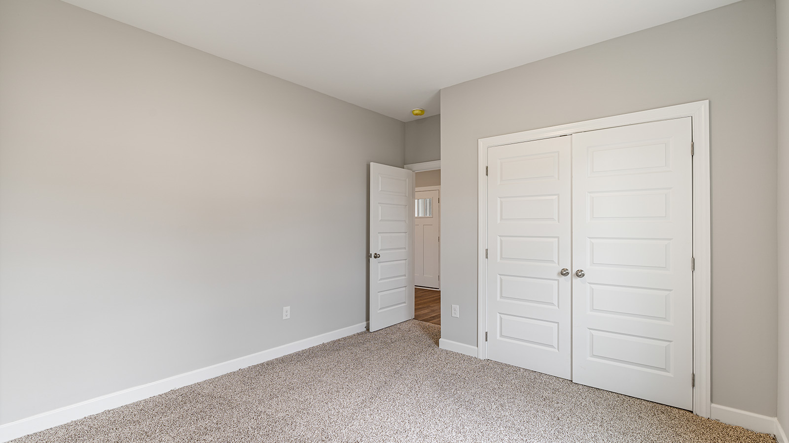 The Hawthorne floorplan bedroom with carpet and a ceiling fan