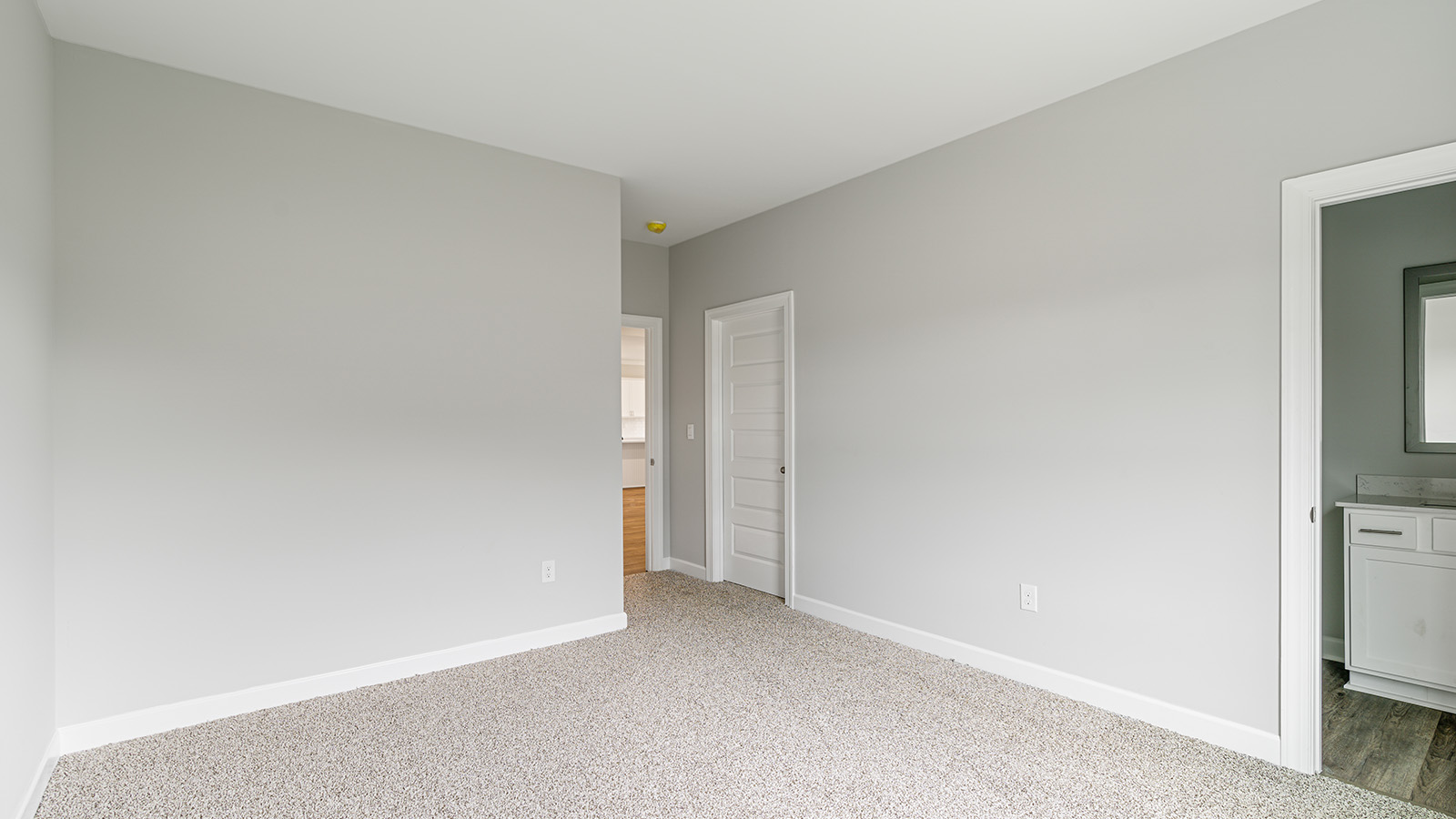 The Hawthorne floorplan bedroom with carpet and a ceiling fan