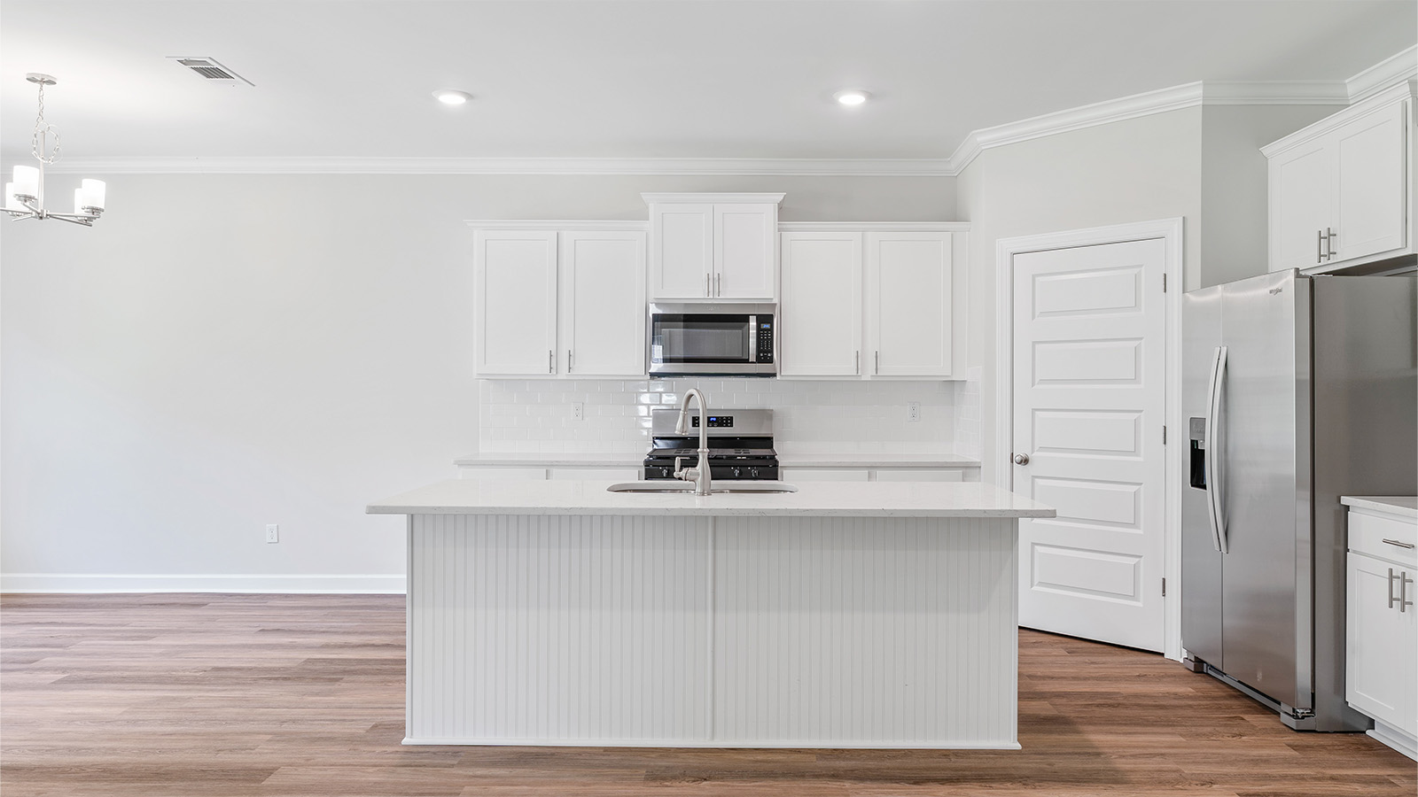 luxury vinyl plank flooring in kitchen with stainless steel appliances and Quartz countertops with soft close cabinets