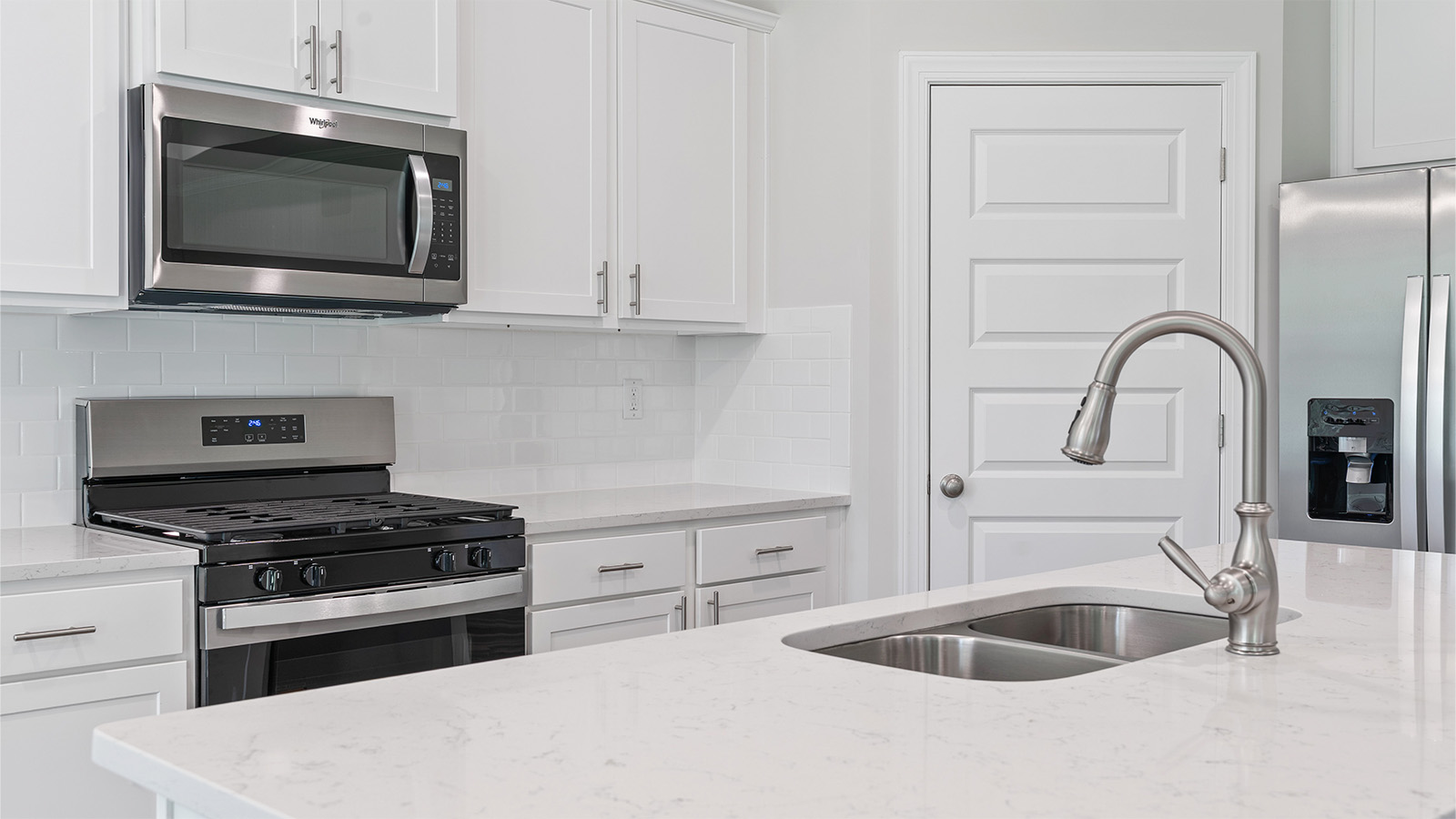luxury vinyl plank flooring in kitchen with stainless steel appliances and Quartz countertops with soft close cabinets