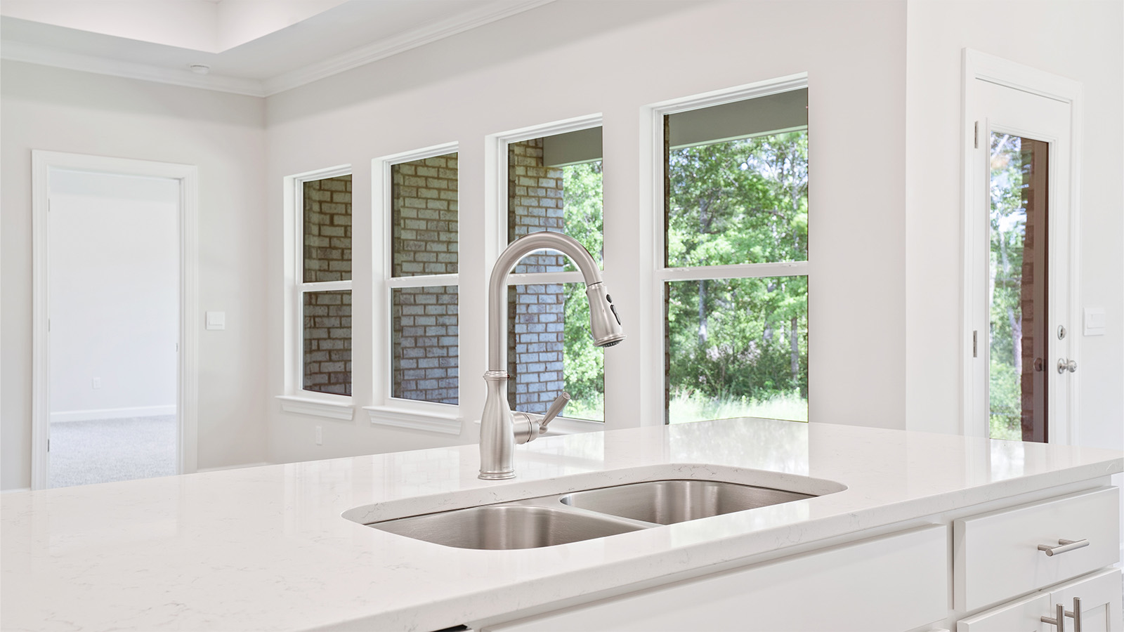 luxury vinyl plank flooring in kitchen with stainless steel appliances and Quartz countertops with soft close cabinets