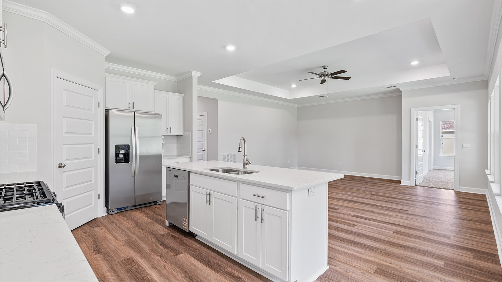 luxury vinyl plank flooring in kitchen with stainless steel appliances and Quartz countertops with soft close cabinets