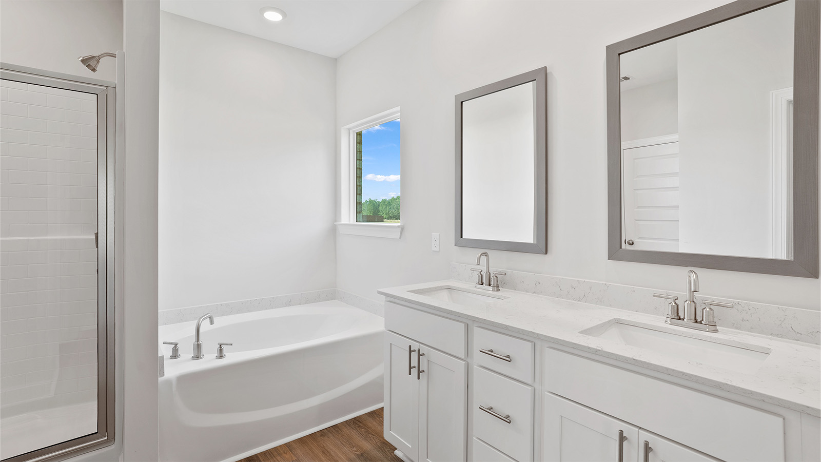 luxury vinyl plan flooring in bathrooms with quartz countertops