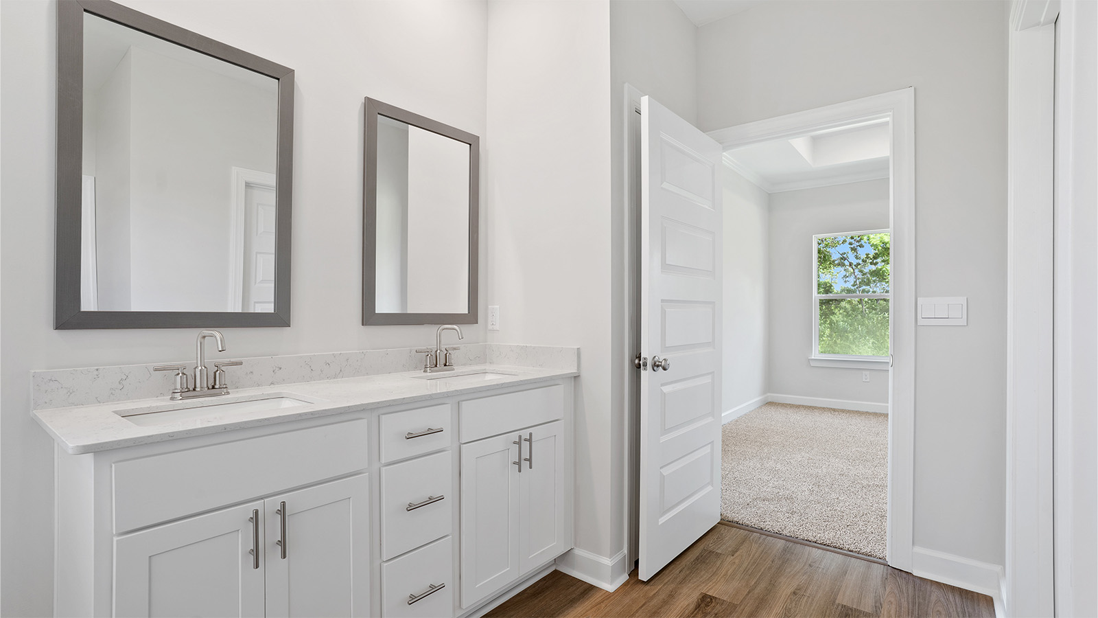 luxury vinyl plan flooring in bathrooms with quartz countertops