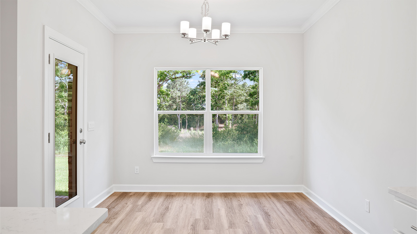 The Madison floorplan kitchen with quartz countertops, soft close cabinets, and LVP flooring