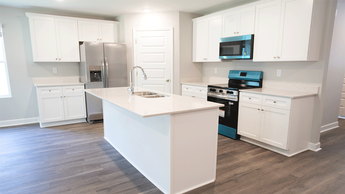 luxury vinyl plank flooring in kitchen with stainless steel appliances and Quartz countertops with soft close cabinets