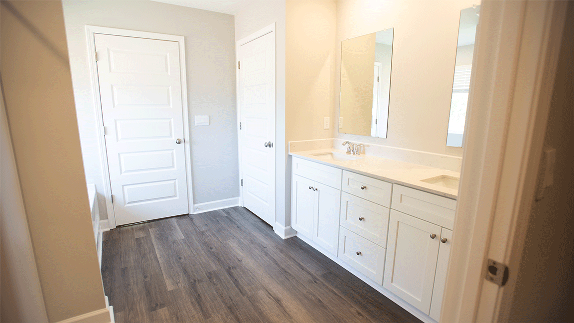 luxury vinyl plan flooring in bathrooms with quartz countertops