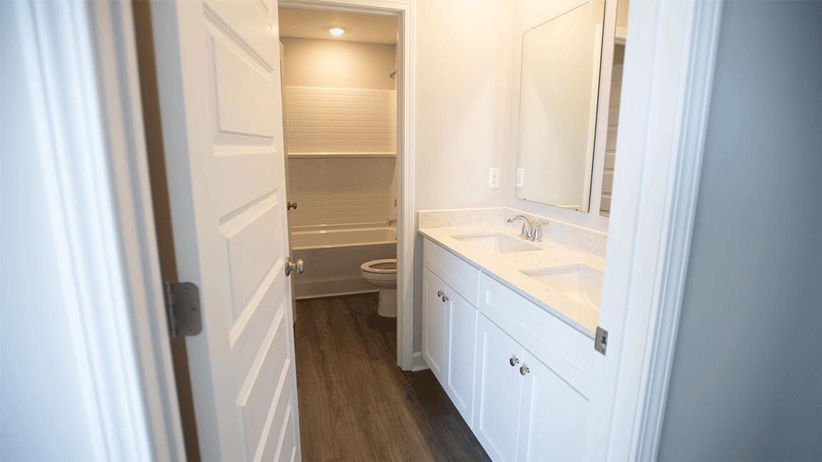 luxury vinyl plan flooring in bathrooms with quartz countertops