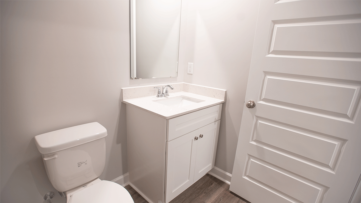luxury vinyl plan flooring in bathrooms with quartz countertops