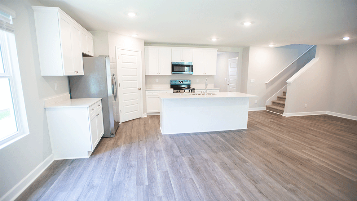 The Oxford floorplan kitchen with LVP flooring and quartz countertops