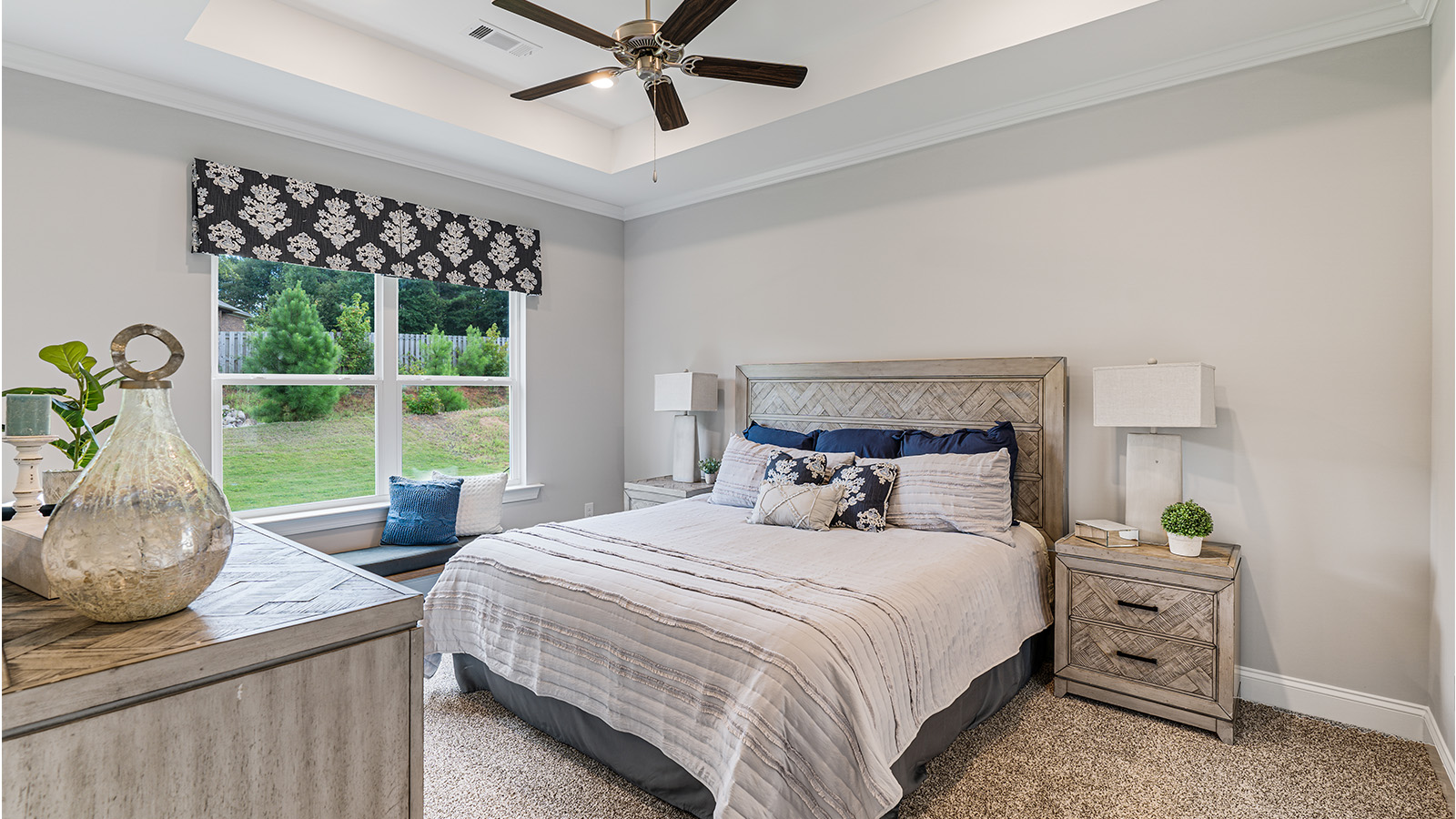 Primary bedroom featuring plush carpet and abundant natural light