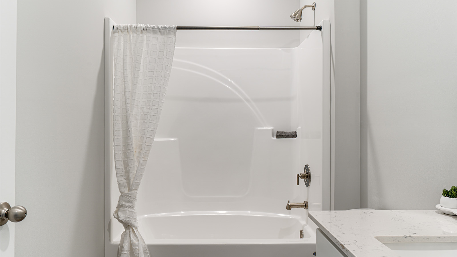Full bath with tub/shower combo and durable surfaces