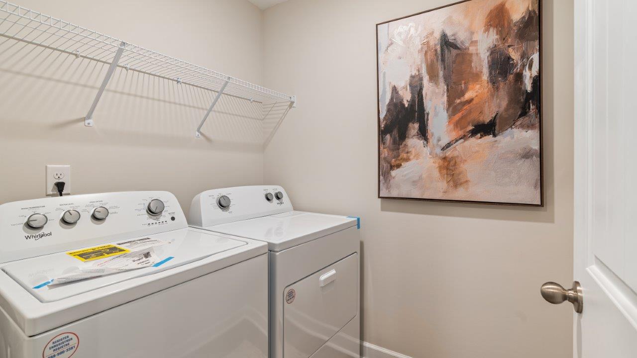 Spacious laundry area with durable flooring and storage options