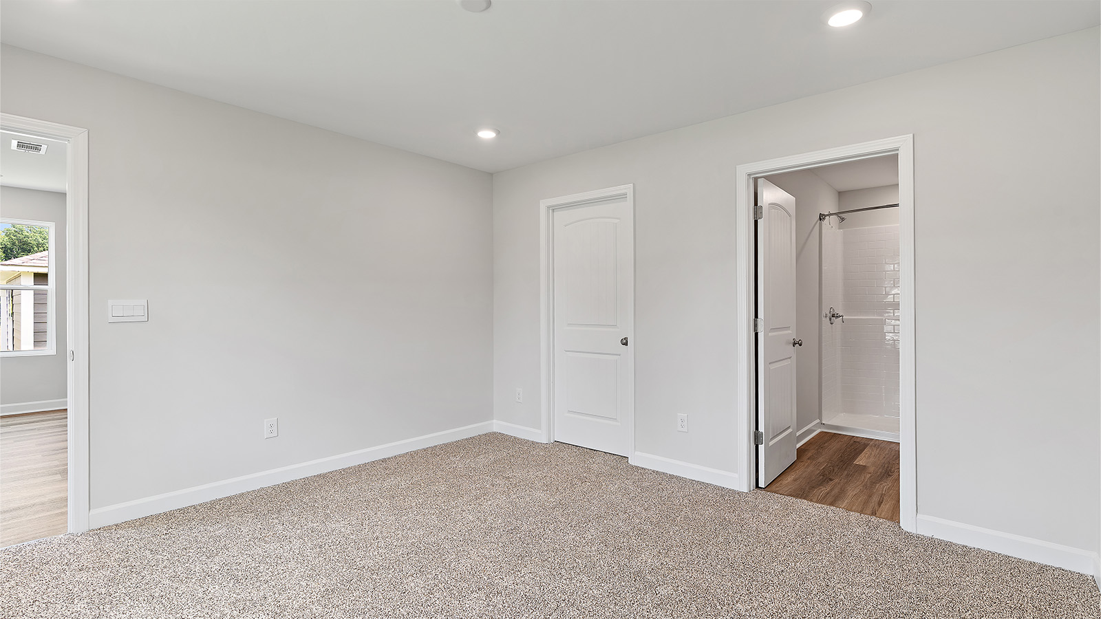Spacious secondary bedroom with soft carpet and full closet