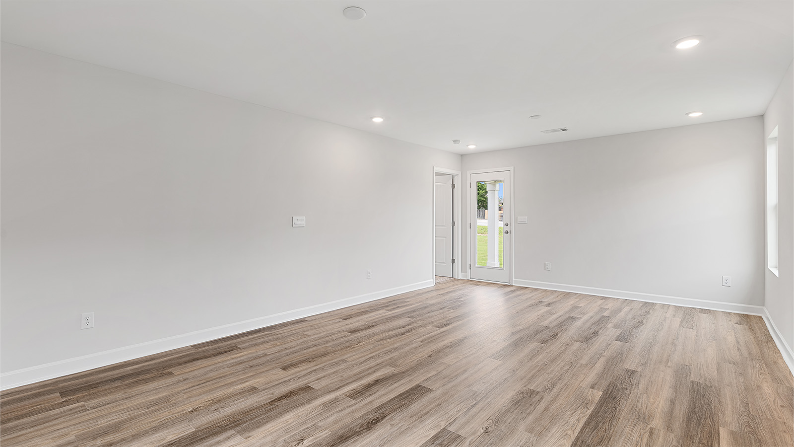 Open family room with abundant natural light and LVP throughout