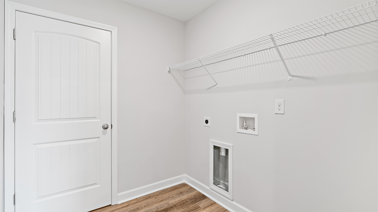 Dedicated laundry room with built in shelving and easy garage access
