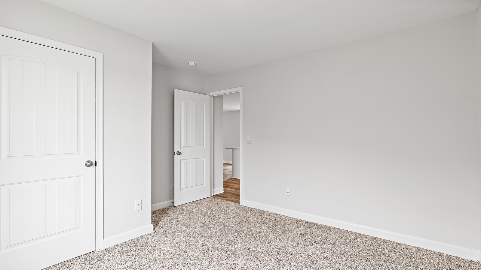 Comfortable guest bedroom with natural light and storage
