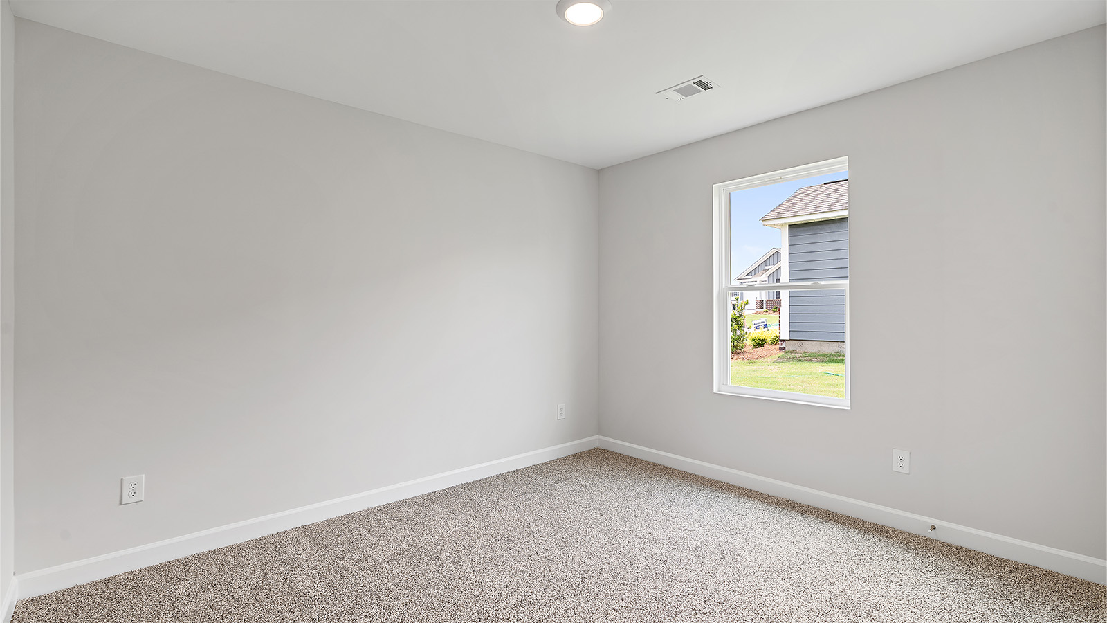 Comfortable guest bedroom with natural light and storage