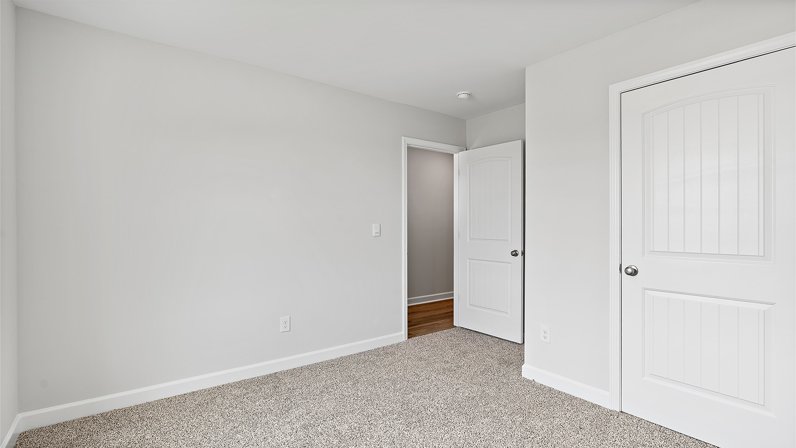 Comfortable guest bedroom with natural light and storage