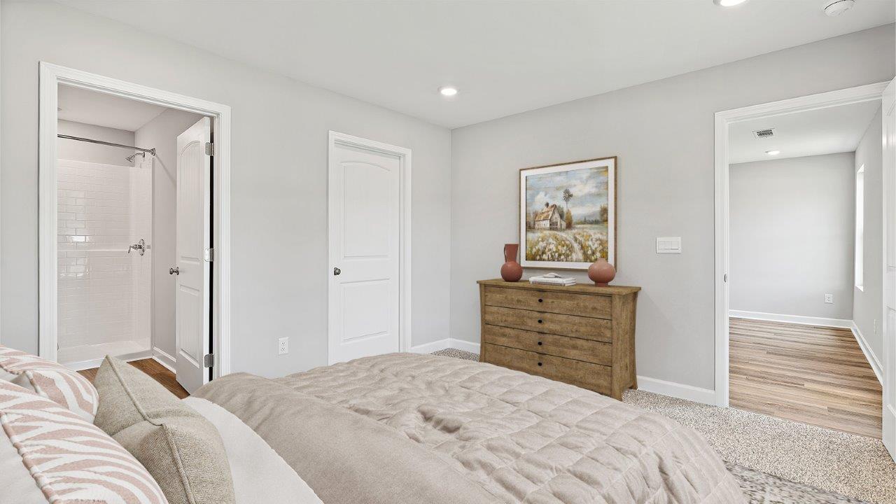 Peaceful primary suite offering a roomy layout and inviting carpeted floors.