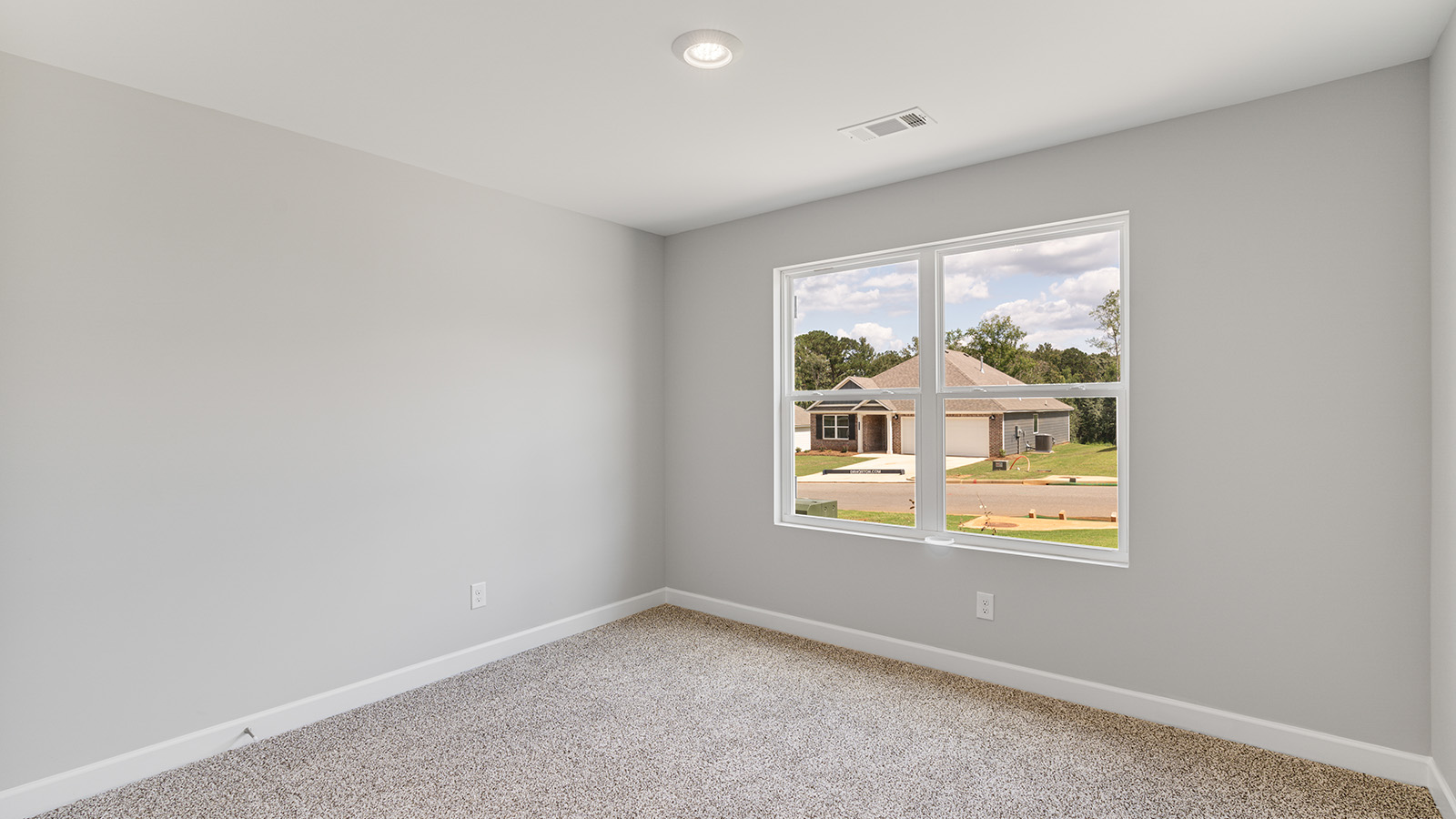 Primary bedroom featuring plush carpet and abundant natural light