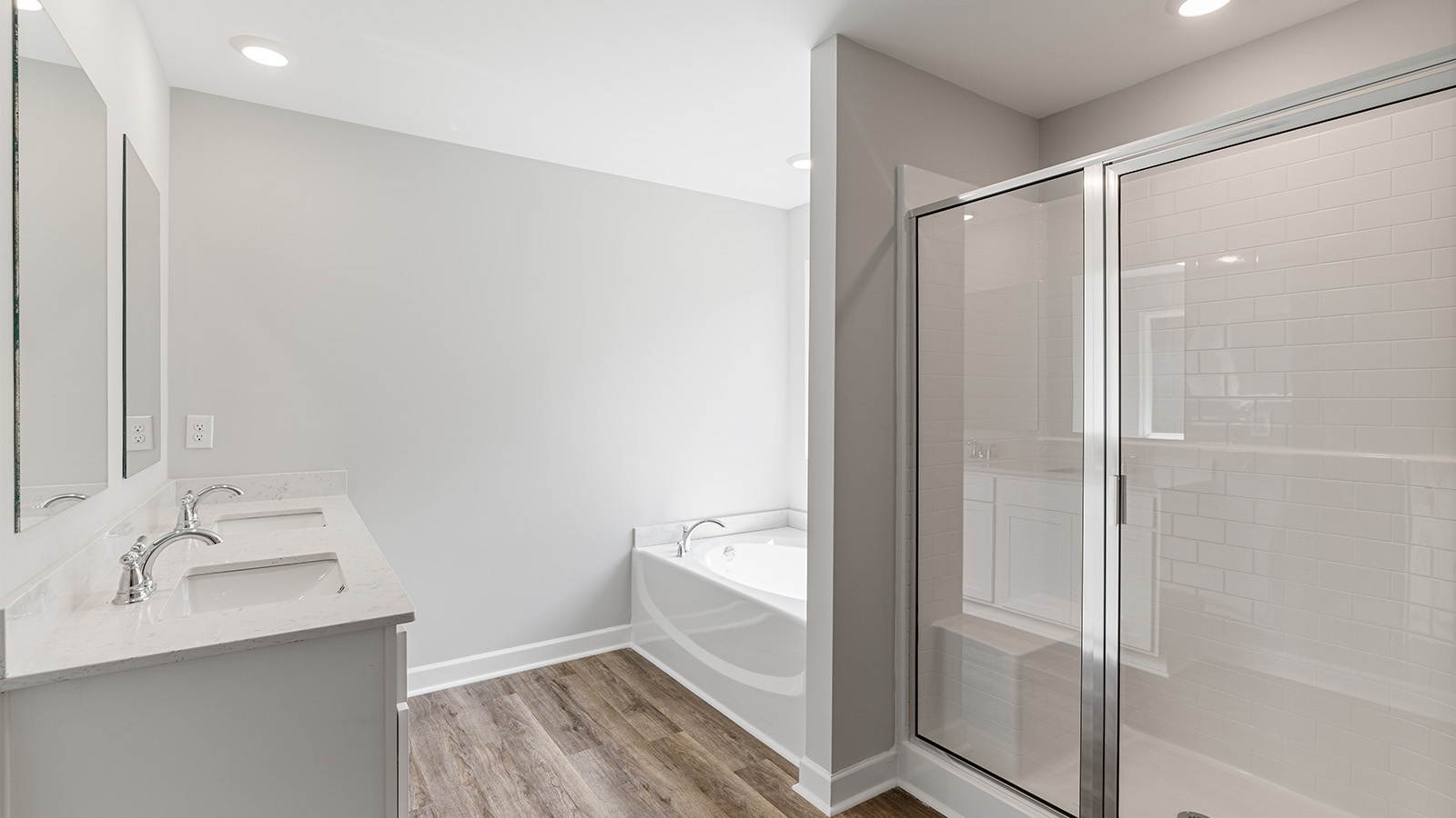 luxury vinyl plan flooring in bathrooms with quartz countertops