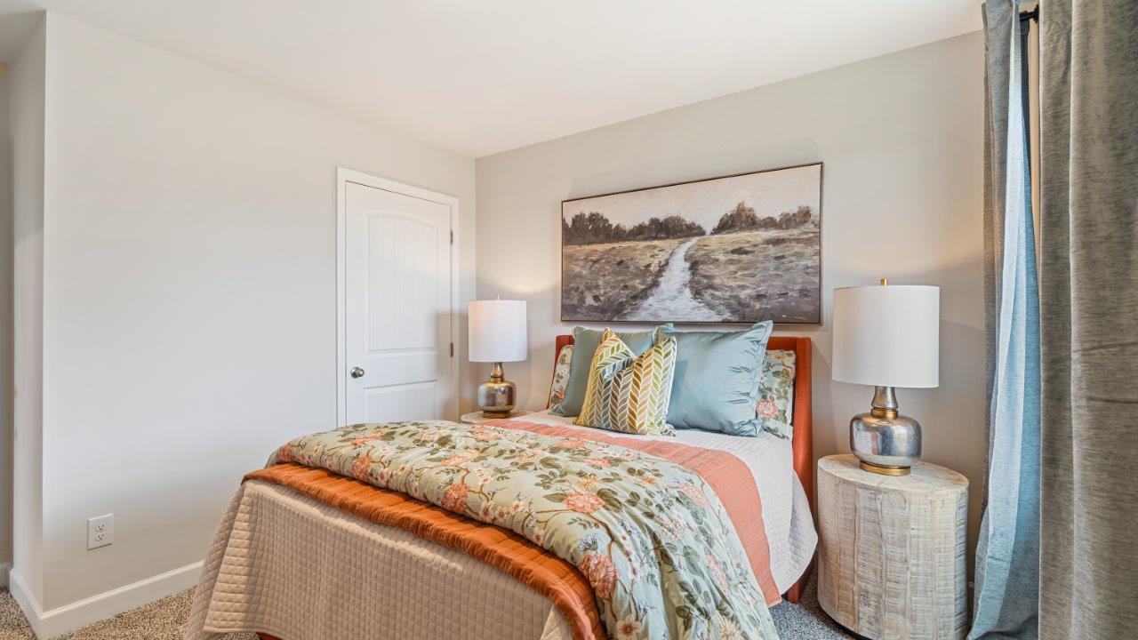Well appointed guest room featuring carpet flooring and a roomy closet.