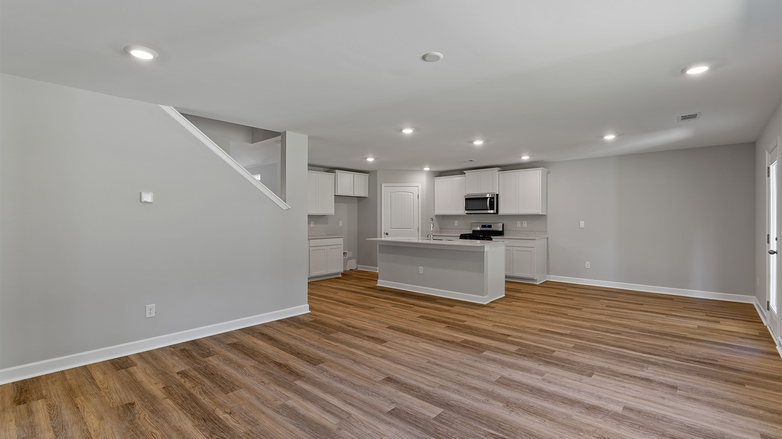 Seamless kitchen to living flow with luxury vinyl plank floors