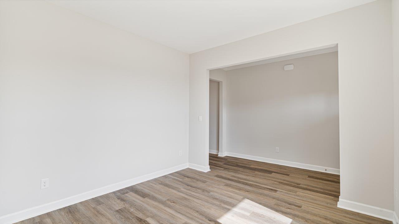 The Carol floorplan interior with quartz countertops, LVP flooring, and open layout.