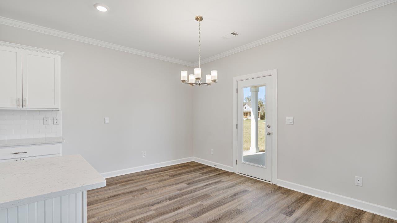 The Carol floorplan interior with quartz countertops, LVP flooring, and open layout.