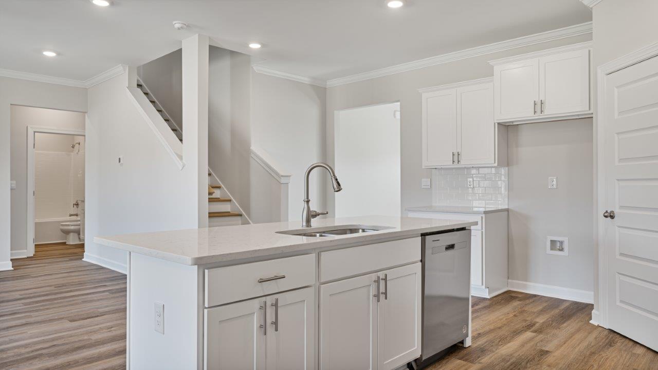 The Carol floorplan interior with quartz countertops, LVP flooring, and open layout.