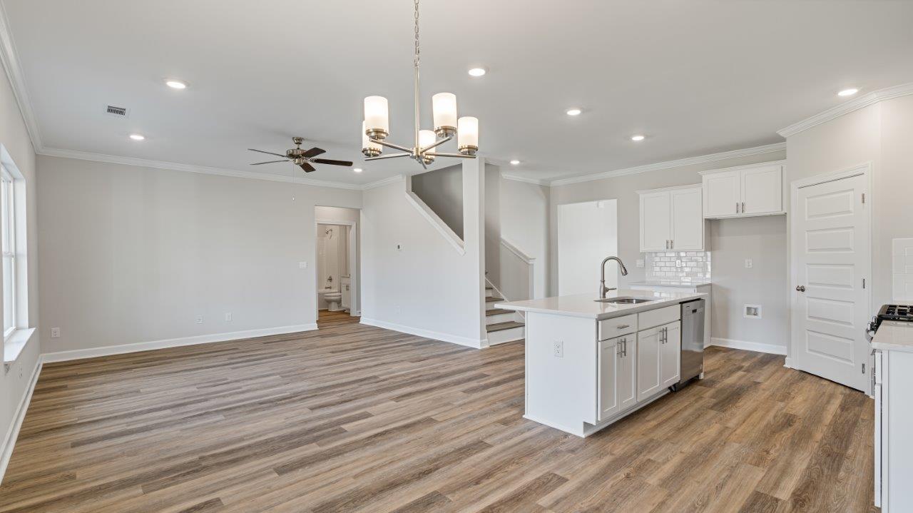 The Carol floorplan interior with quartz countertops, LVP flooring, and open layout.