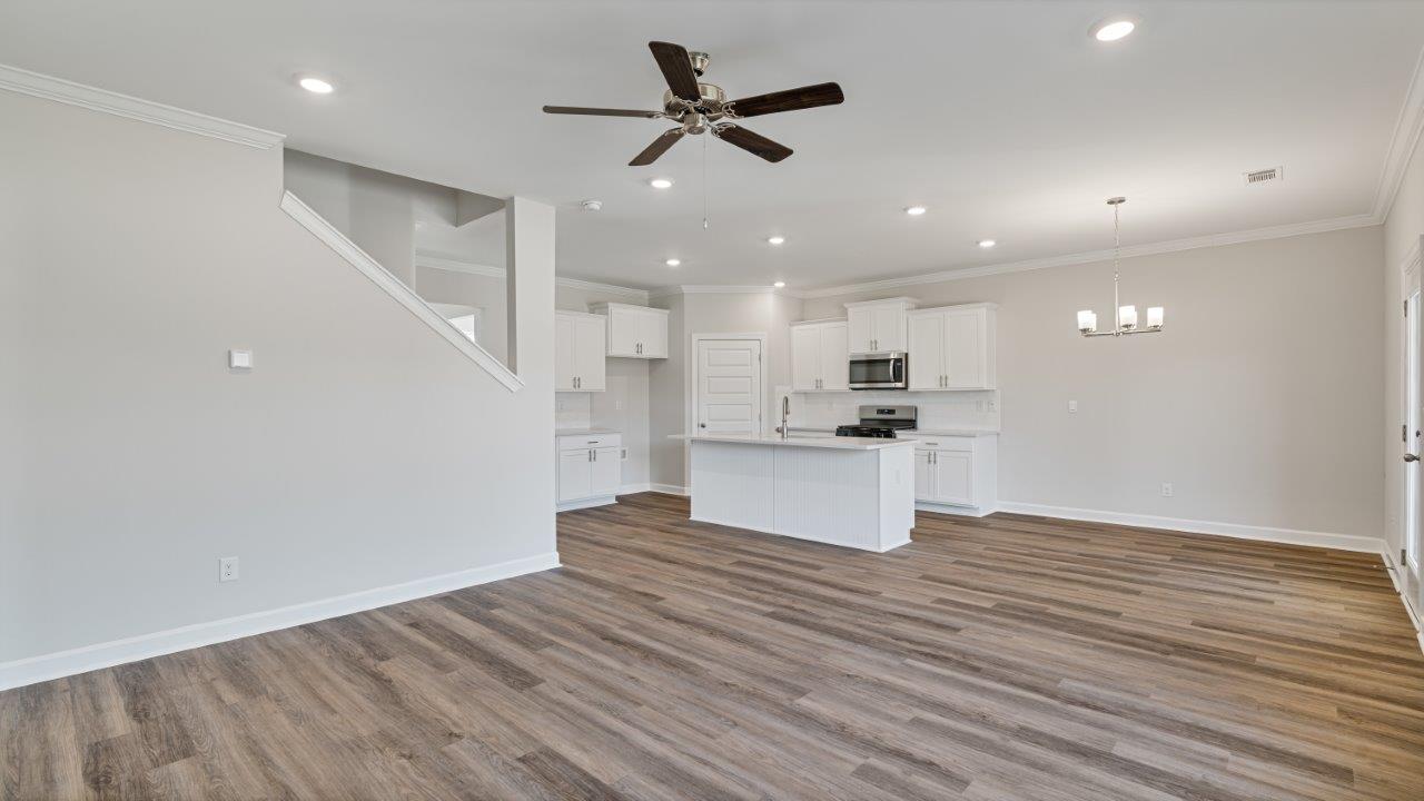 The Carol floorplan interior with quartz countertops, LVP flooring, and open layout.