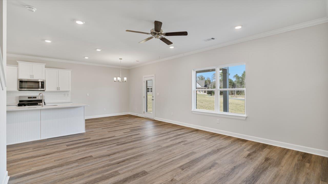 The Carol floorplan interior with quartz countertops, LVP flooring, and open layout.