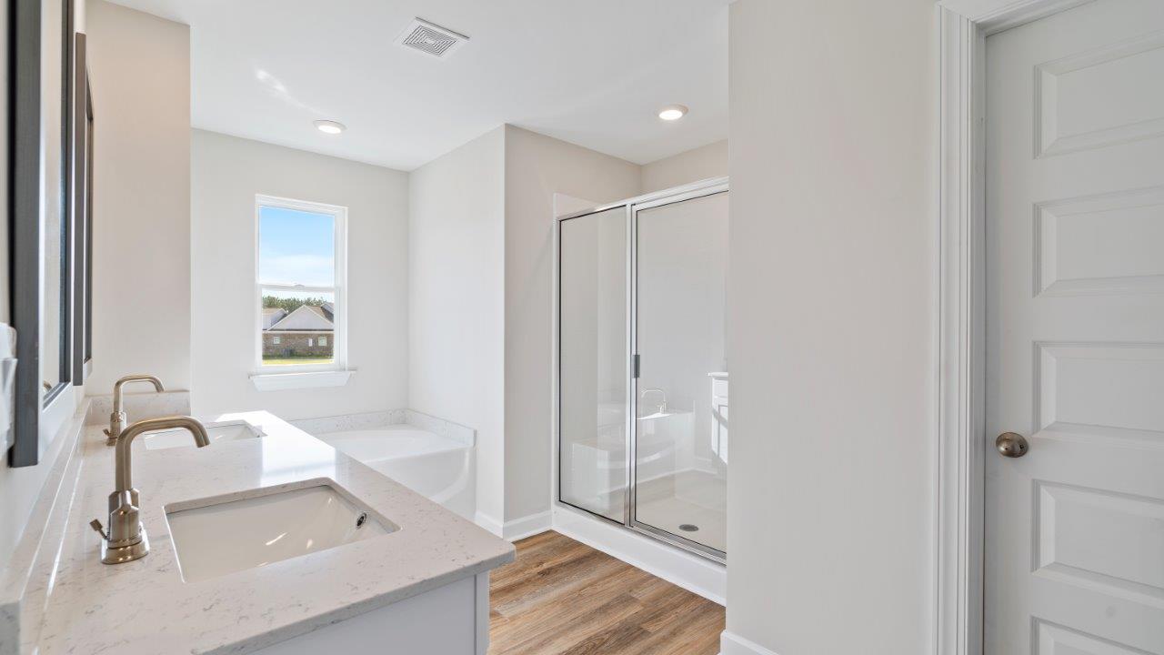 The Carol floorplan interior with quartz countertops, LVP flooring, and open layout.