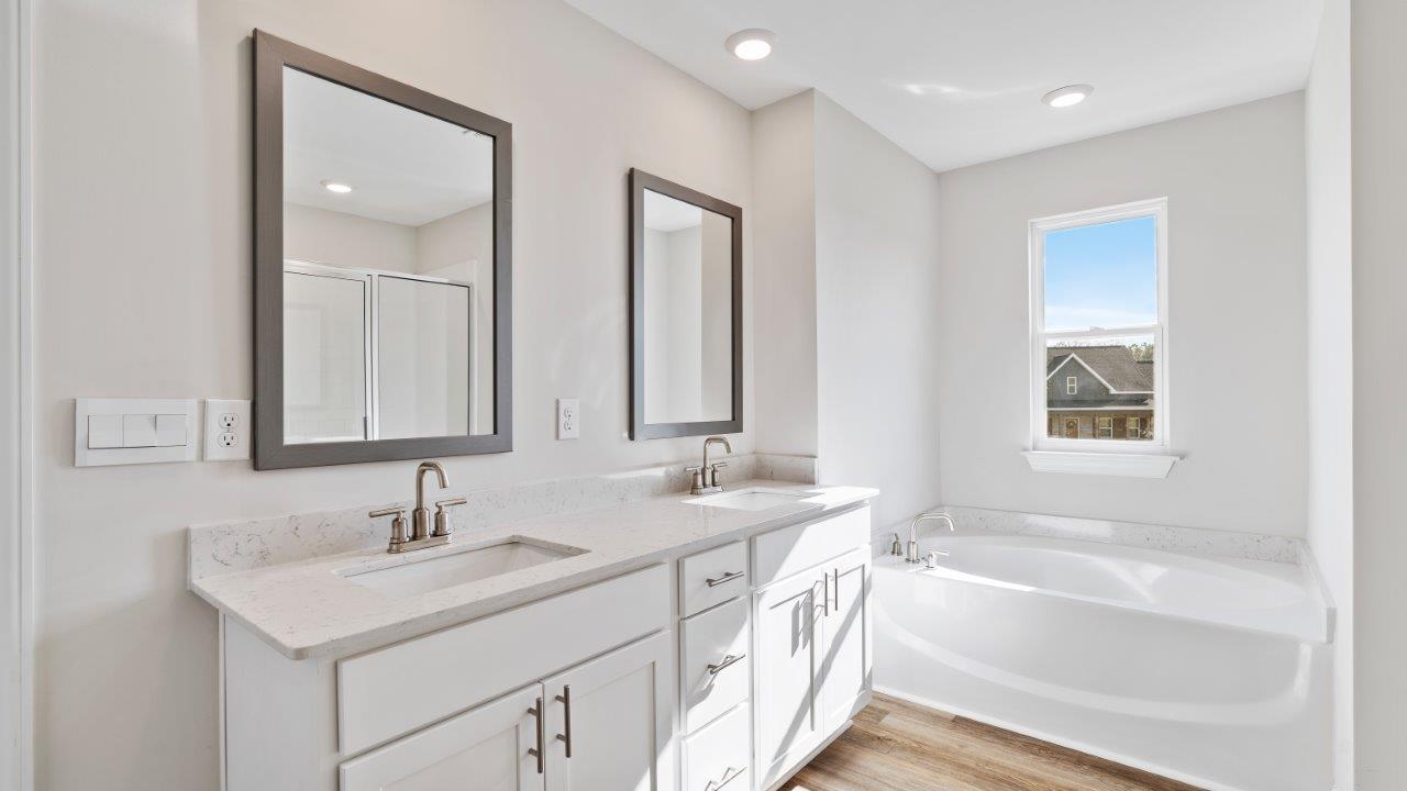 The Carol floorplan interior with quartz countertops, LVP flooring, and open layout.