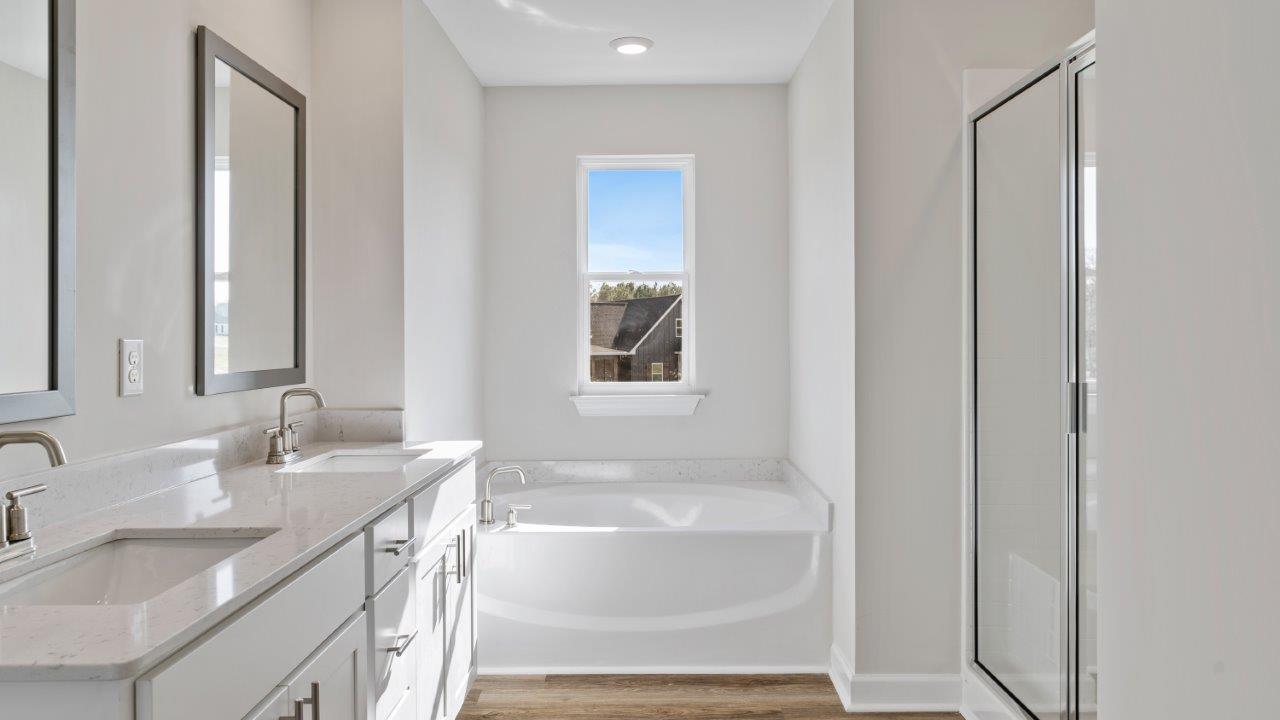 The Carol floorplan interior with quartz countertops, LVP flooring, and open layout.