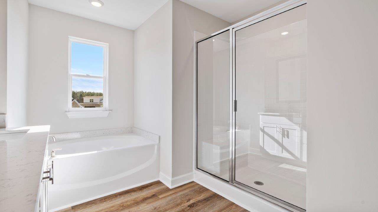 The Carol floorplan interior with quartz countertops, LVP flooring, and open layout.