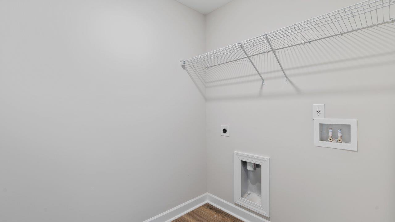 The Carol floorplan interior with quartz countertops, LVP flooring, and open layout.