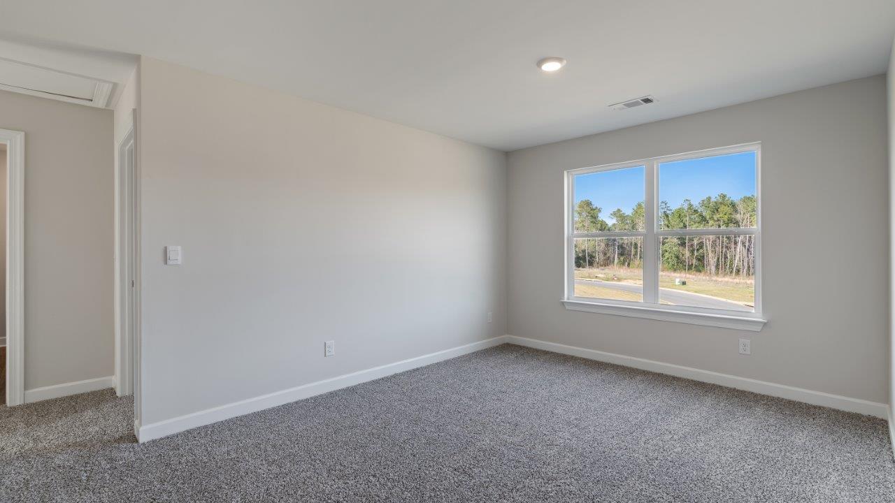 The Carol floorplan interior with quartz countertops, LVP flooring, and open layout.