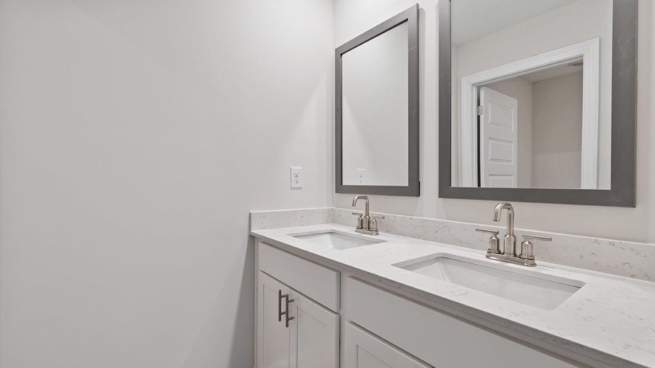 The Carol floorplan interior with quartz countertops, LVP flooring, and open layout.