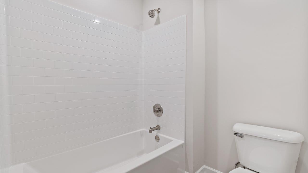 The Carol floorplan interior with quartz countertops, LVP flooring, and open layout.