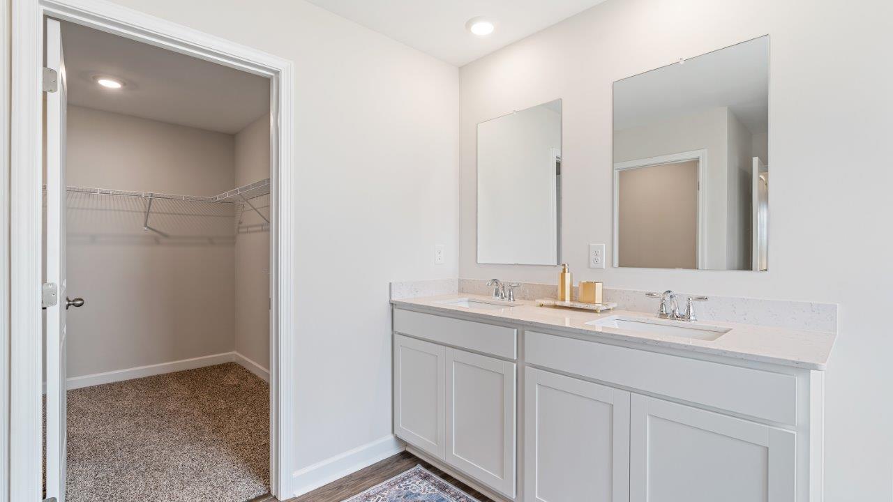 luxury vinyl plan flooring in bathrooms with quartz countertops