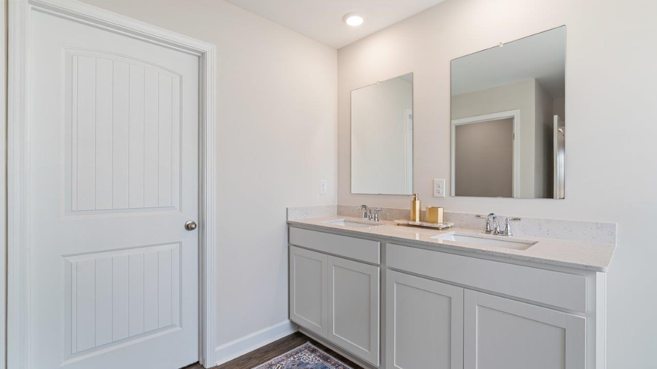 luxury vinyl plan flooring in bathrooms with quartz countertops