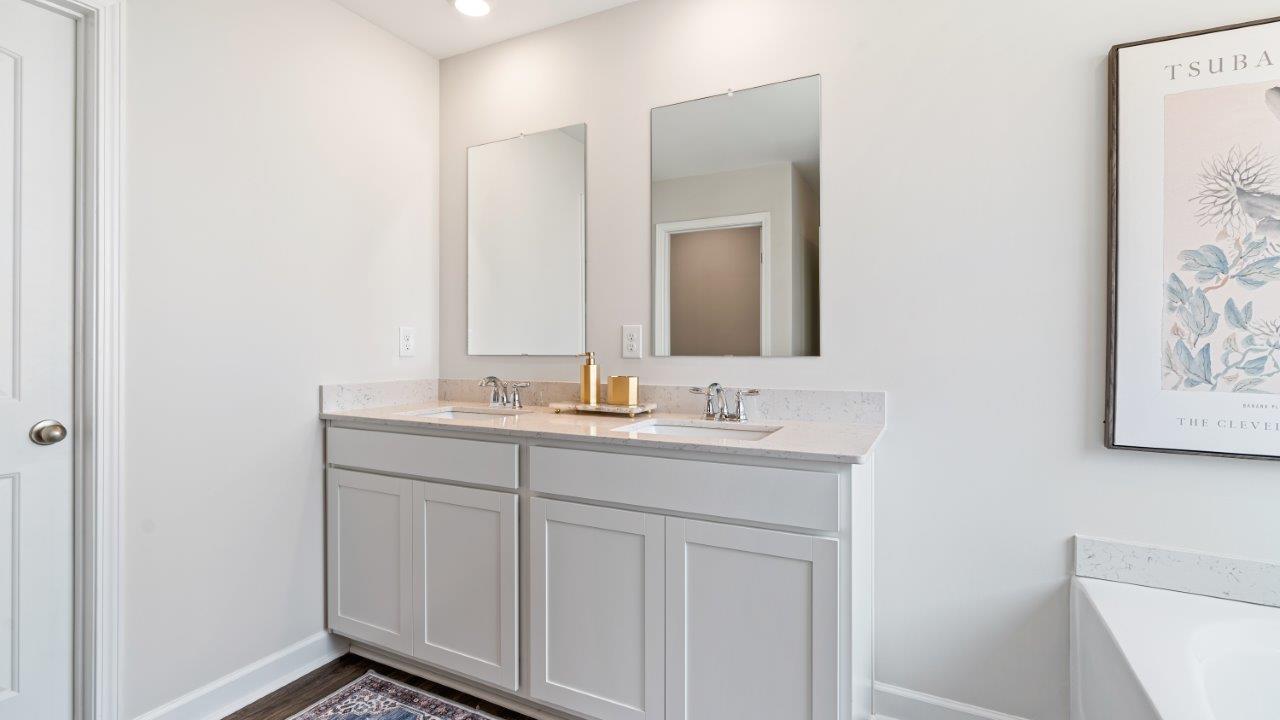 luxury vinyl plan flooring in bathrooms with quartz countertops