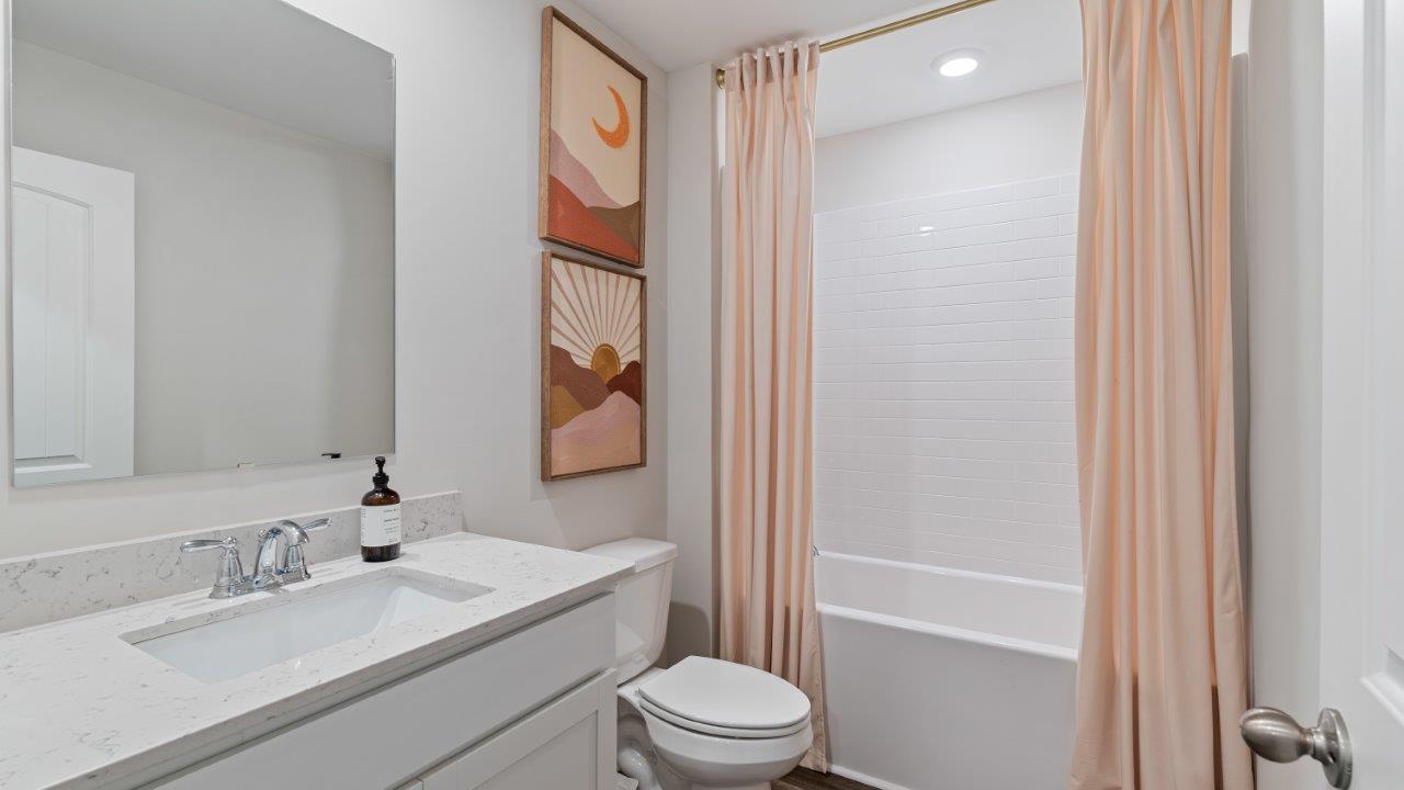 luxury vinyl plan flooring in bathrooms with quartz countertops