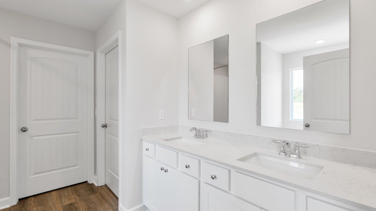luxury vinyl plan flooring in bathrooms with quartz countertops