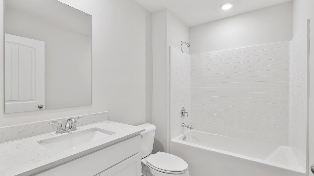 luxury vinyl plan flooring in bathrooms with quartz countertops