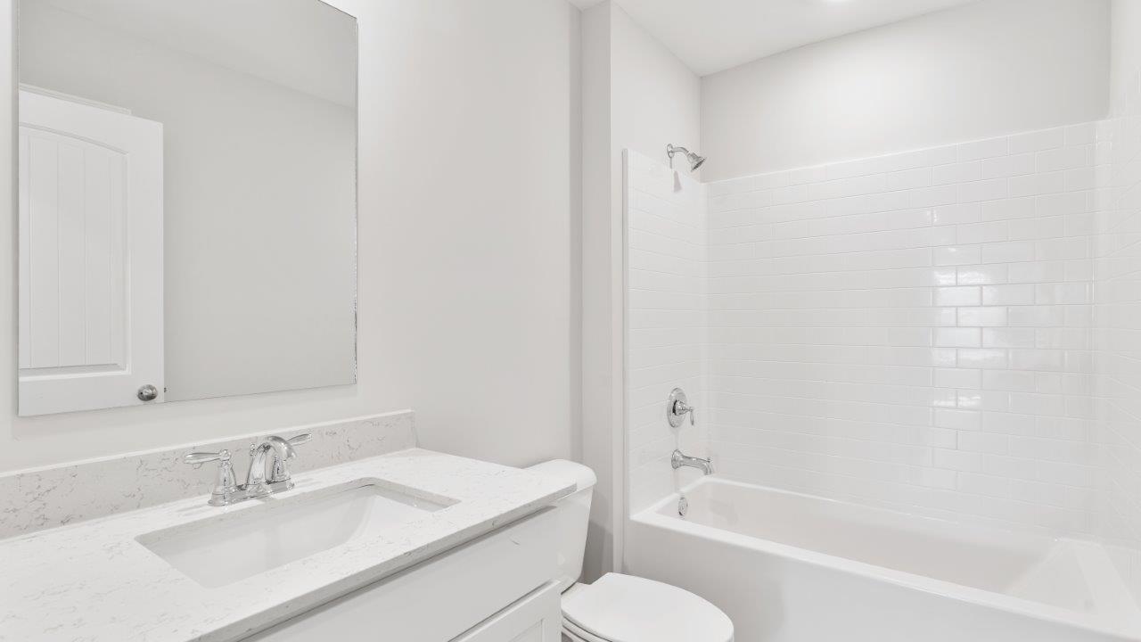 luxury vinyl plan flooring in bathrooms with quartz countertops