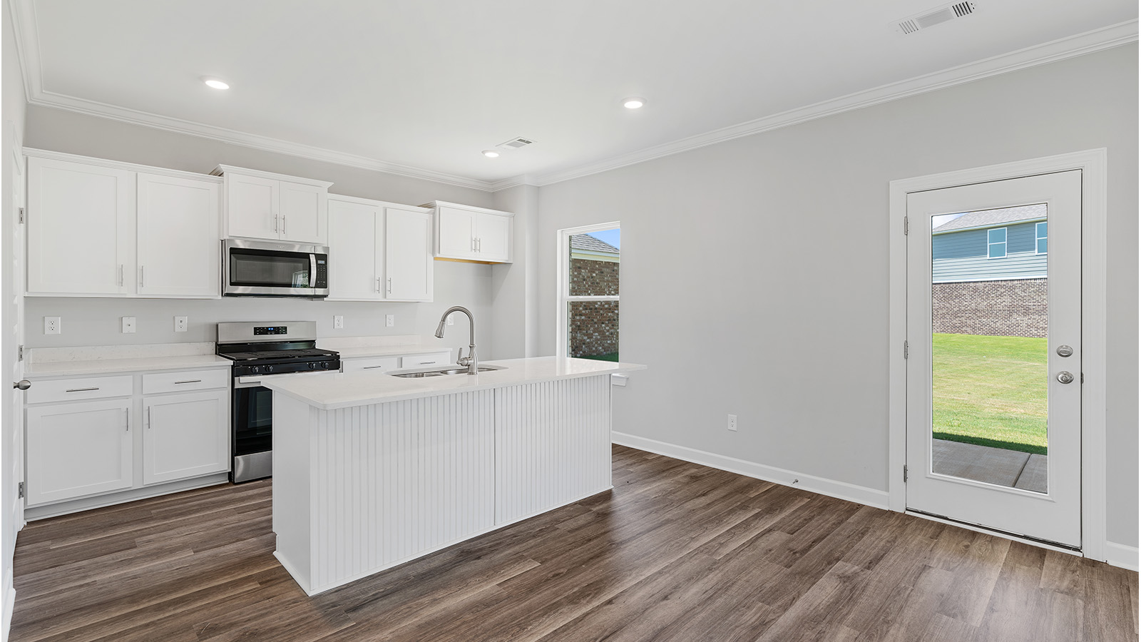 luxury vinyl plank flooring in kitchen with stainless steel appliances and Quartz countertops with soft close cabinets